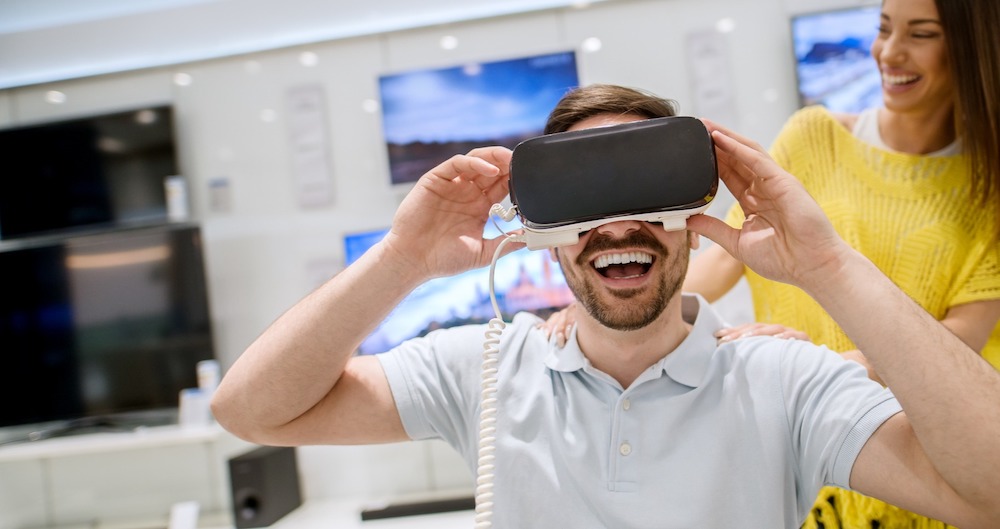 Man smiling while wearing VR goggles