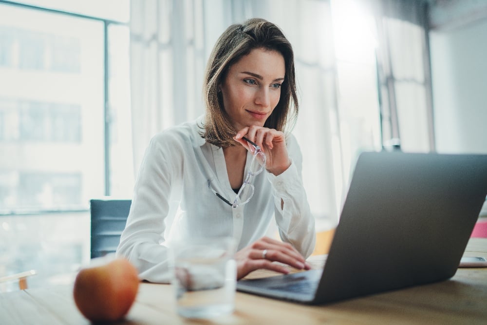 Person sitting at desk using a laptop