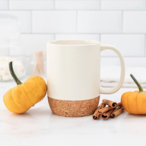 coffee mug with pumpkins and cinnamon sticks